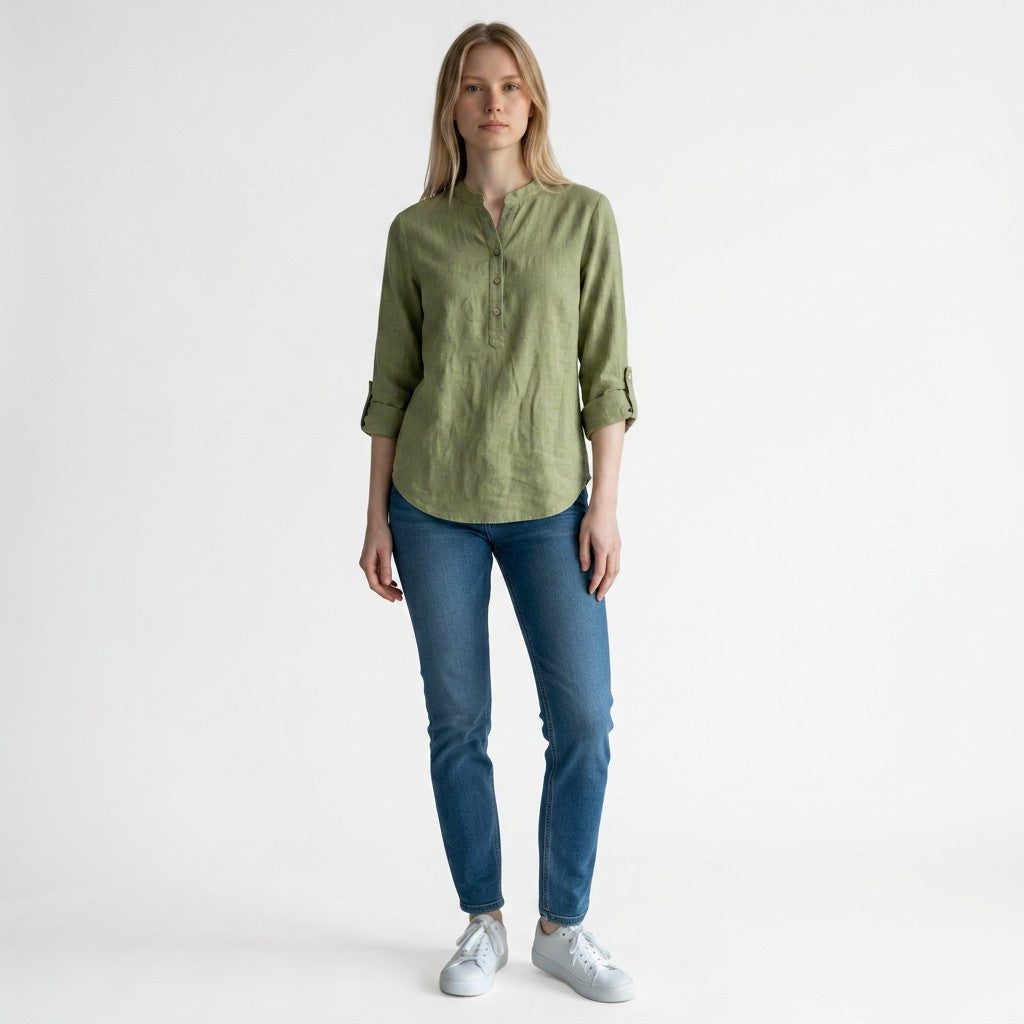 Green linen blouse with V-neck and button placket, three-quarter sleeves rolled at cuffs.