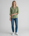Olive green linen blouse with V-neck and button placket, three-quarter rolled sleeves.