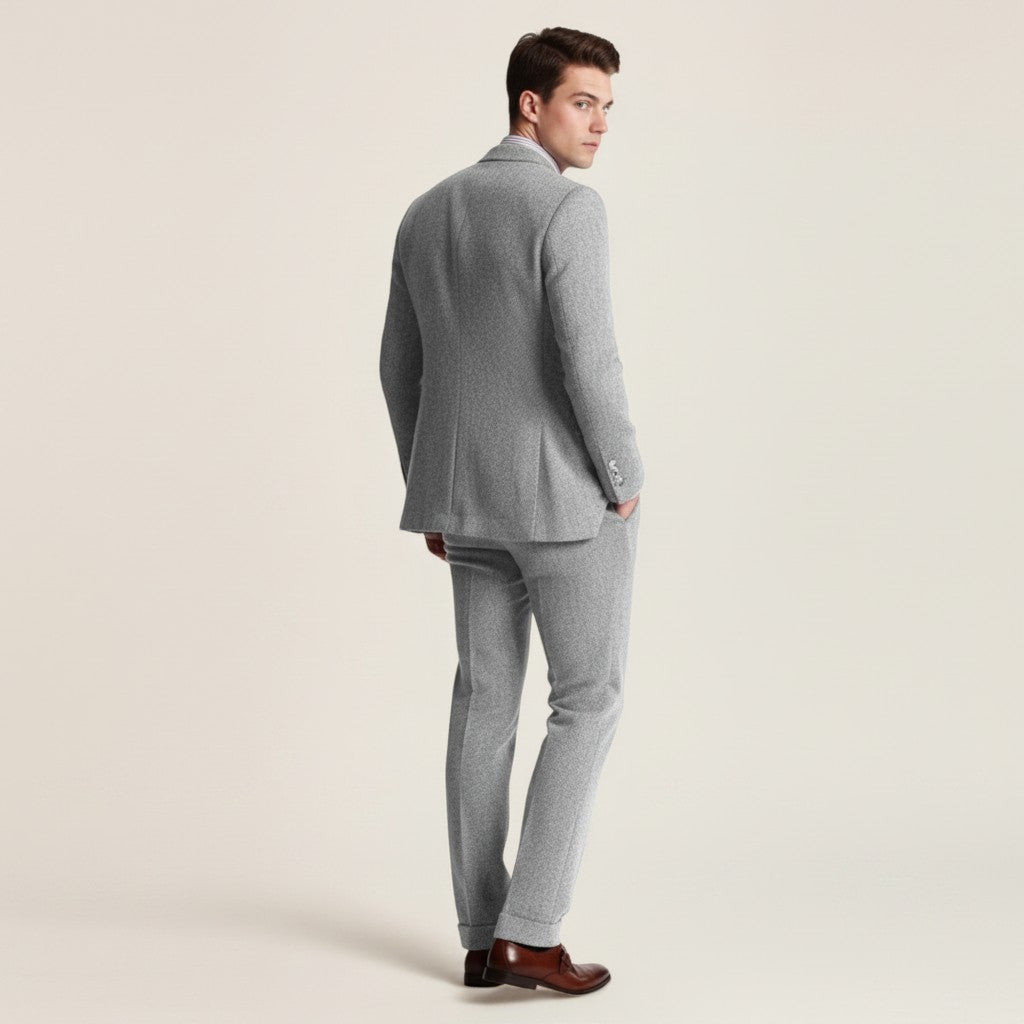 Grey tweed three-piece suit shown in side view: blazer, vest, and slim-fit trousers