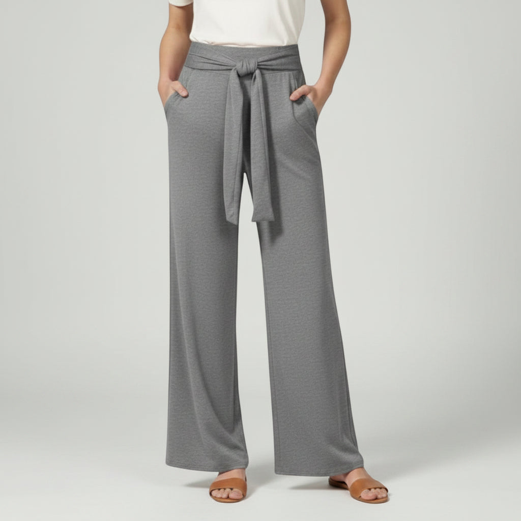 Grey relaxed wide-leg trousers with tie waist and draped front.