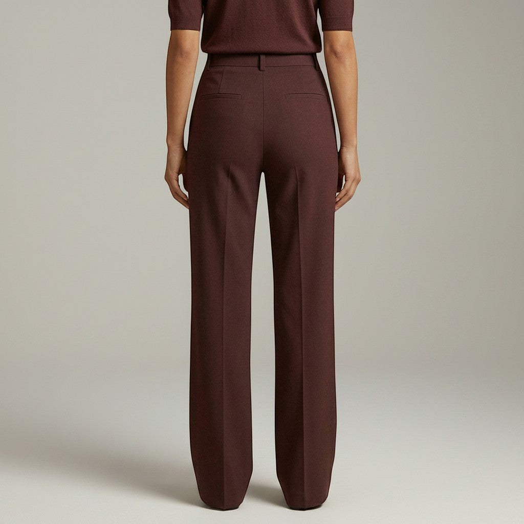 High-waist tailored trousers in deep plum with crease lines and front button closure