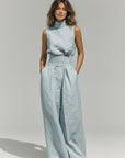 Light blue sleeveless high-neck tank top and wide-leg trousers set, draped waist