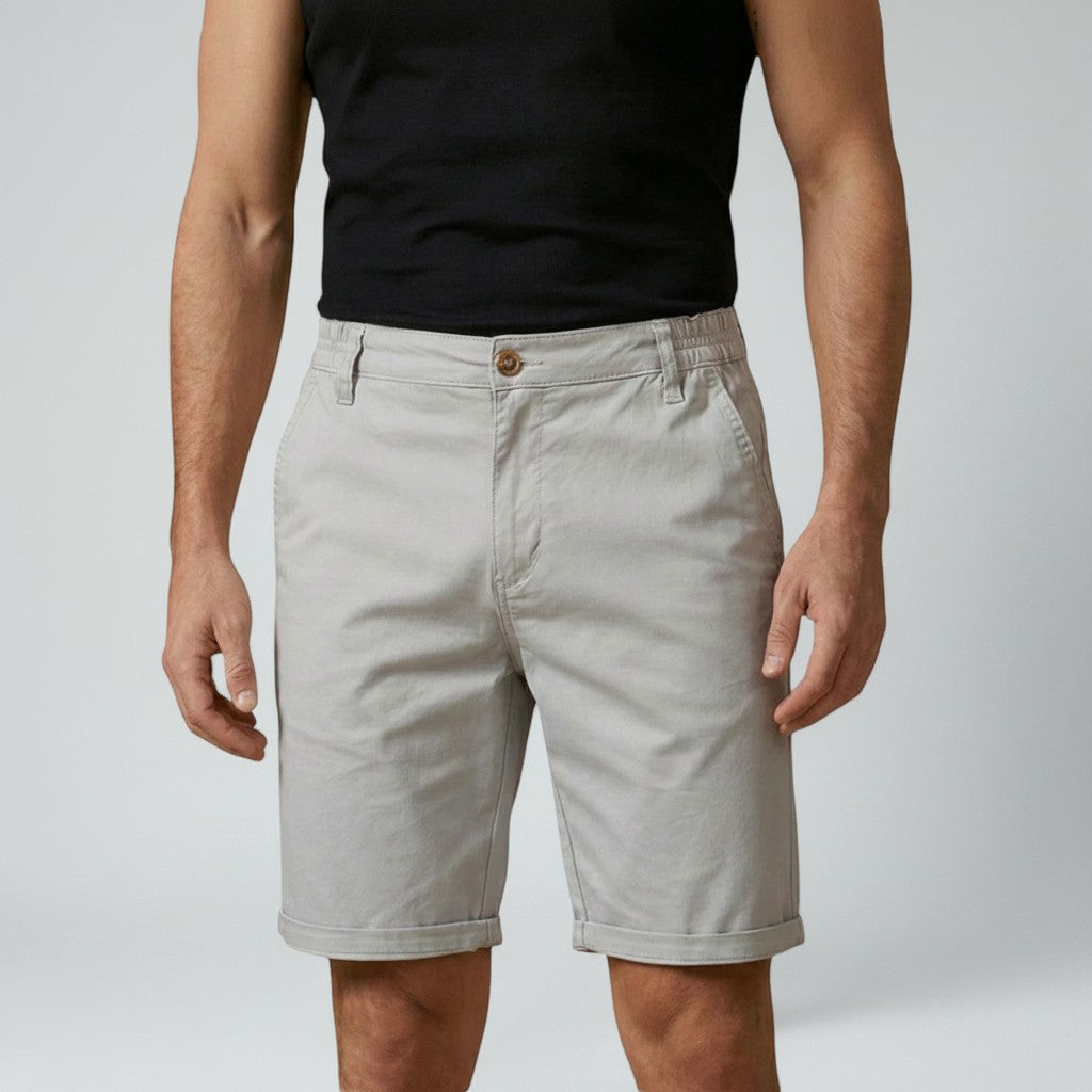 Men's chino shorts in beige, relaxed fit, front view with button fly and belt loops