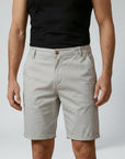 Men's chino shorts in beige, relaxed fit, front view with button fly and belt loops