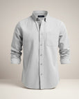 Slim fit long-sleeve button-up shirt in light color with chest pocket and button placket