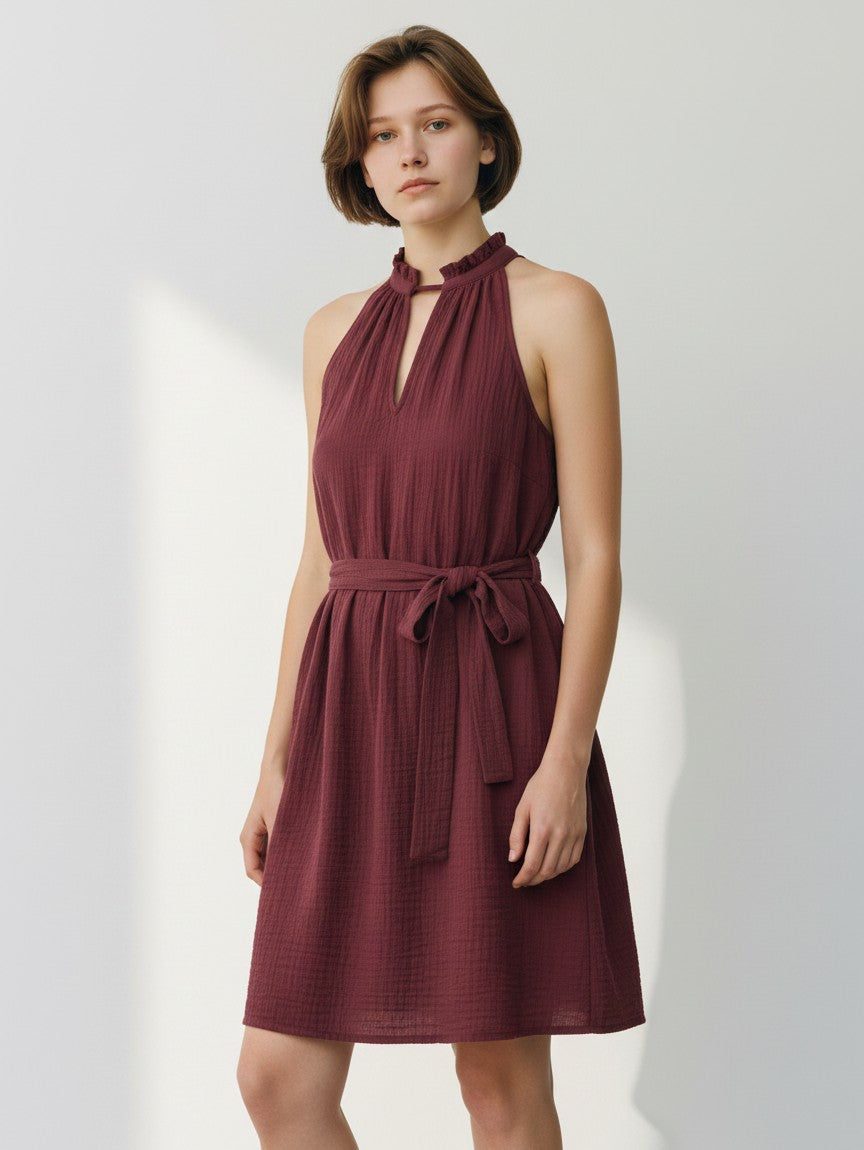Sleeveless halter-style dress with high gathered neck and tie waist in burgundy