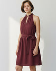 Sleeveless halter-style dress with high gathered neck and tie waist in burgundy