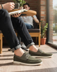 Men's dark green slip-on driving loafers with lace-up panels and white flat sole