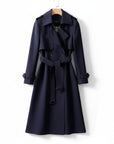 Navy long trench coat with double-breasted buttons, belted waist, and shoulder epaulets.