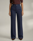 High-waist tailored trousers in navy blue with belt loops and front button closure