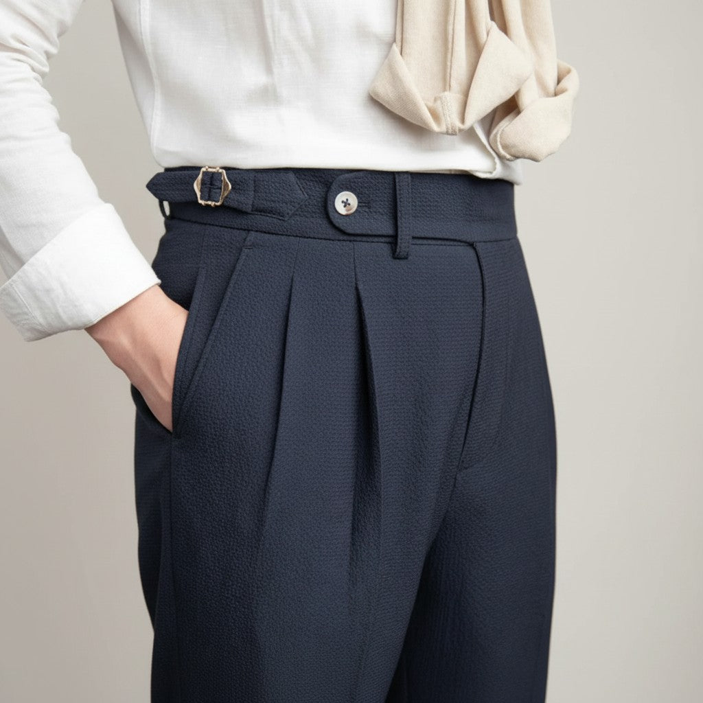 High-waisted tailored trousers in dark navy, pleated front and belt buckle