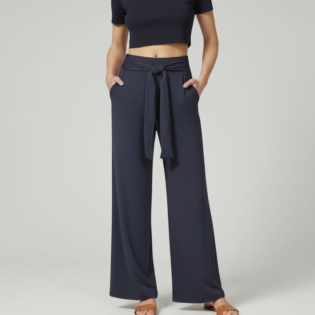 Dark blue relaxed wide-leg trousers with tie waist and draped front.