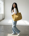 Corduroy tote bag in dark yellow with ribbed texture and two top handles