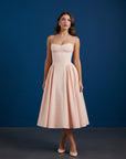 Blush fitted midi dress with adjustable spaghetti straps and flared gathered skirt