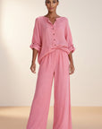 Pink button-front blouse and wide-leg trousers set, rolled sleeves