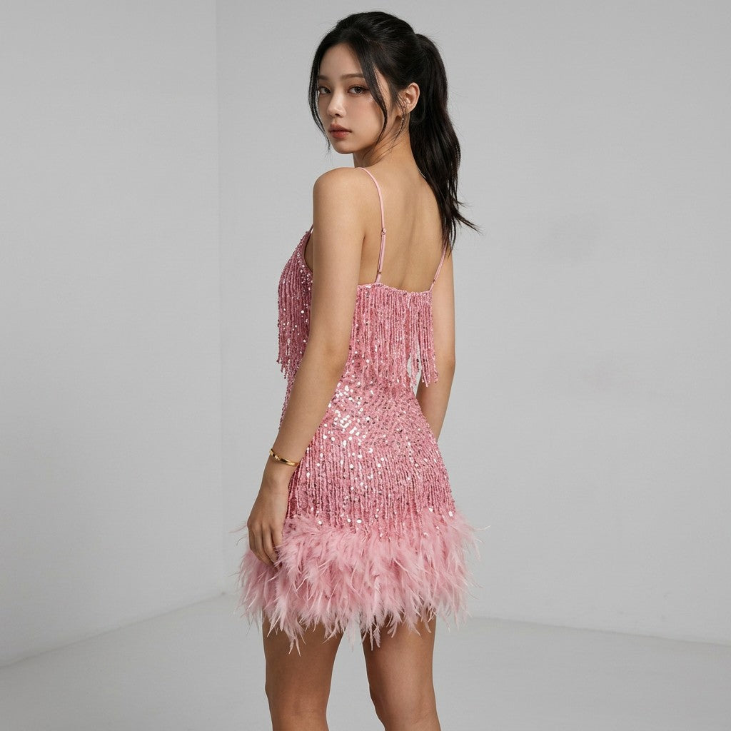 Pink sequin mini dress with spaghetti straps and feather fringe hem