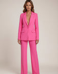 Pink tailored suit with V-neck blazer and wide-leg trousers, matching pockets