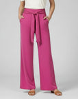 Purple relaxed wide-leg trousers with tie waist and draped front.