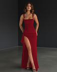 Burgundy evening maxi dress with fitted bodice, square neckline, and side slit