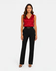 Red satin sleeveless V-neck blouse with draped neckline.