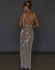 Embellished evening gown, open-back style with thin straps, long column fit in silver.