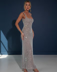 Embellished evening gown with square neckline, sleeveless straps, and long column fit in silver.