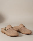 Beige slip-on orthopedic slippers with metal buckle accent and perforated upper.