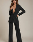 Black tailored suit with deep V-neck blazer and wide-leg trousers, long sleeves