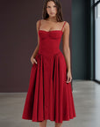 Red fitted midi dress with adjustable spaghetti straps and gathered pleated skirt