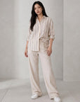 Cream striped button-up blouse with chest pocket, rolled sleeves, and blue vertical stripes.
