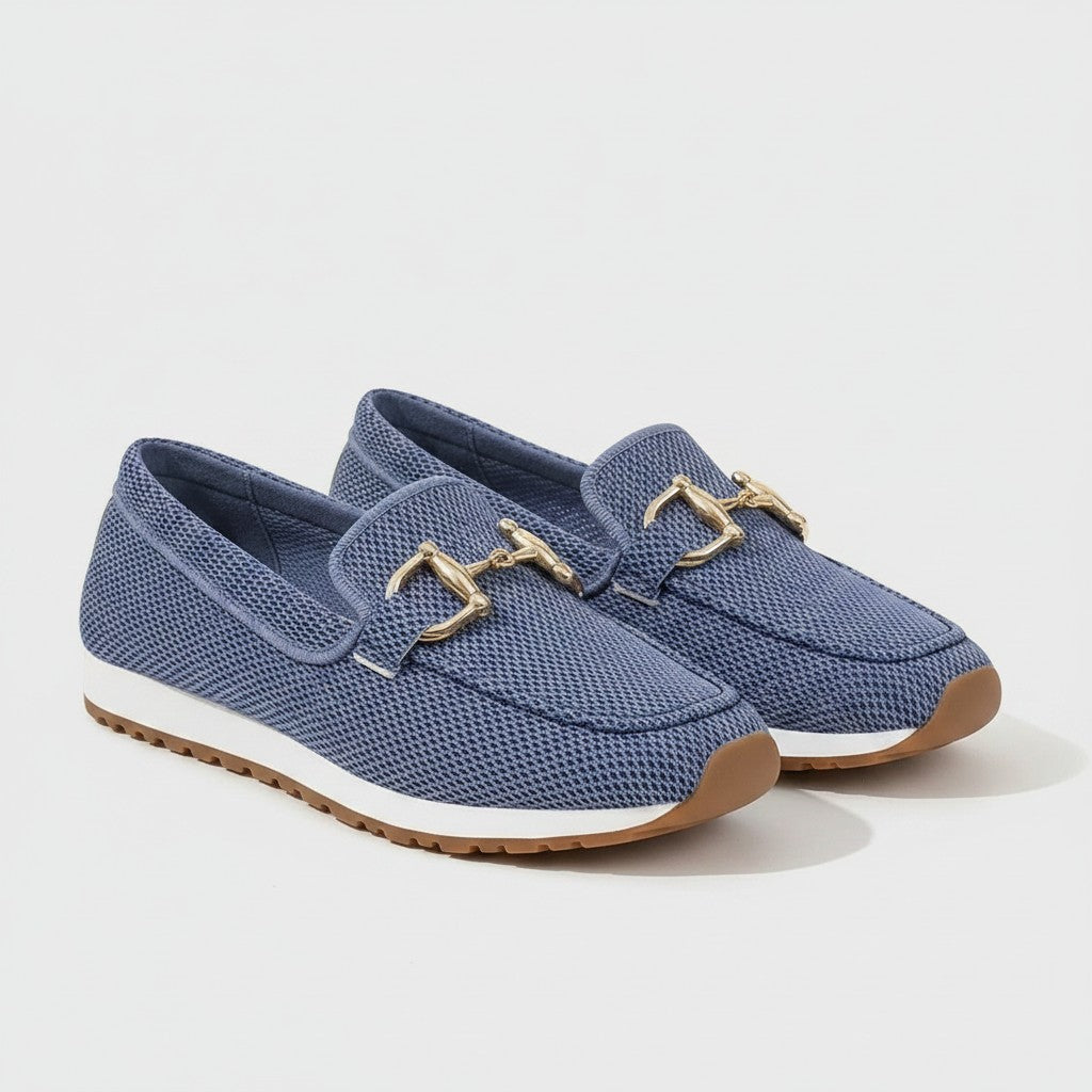 Blue slip-on loafers with gold metal bit detail and textured upper, grippy sole.