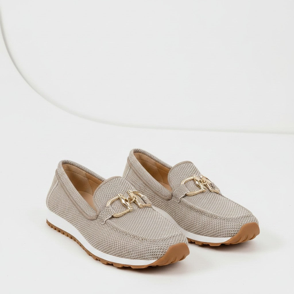 Beige textured slip-on loafers with gold metal bit detail and tan outsole.