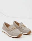 Beige textured slip-on loafers with gold metal bit detail and tan outsole.