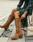 Brown suede cowboy boots, pull-on style with pointed toe and low block heel