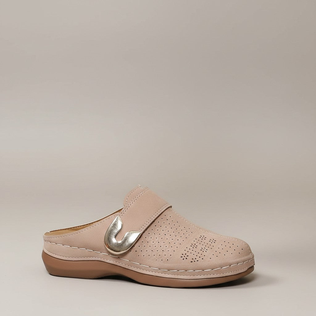 Light beige slip-on mules with metal buckle accent and perforated upper.