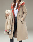 Beige waterproof hooded parka with drawstring waist, button front, red-lined hood