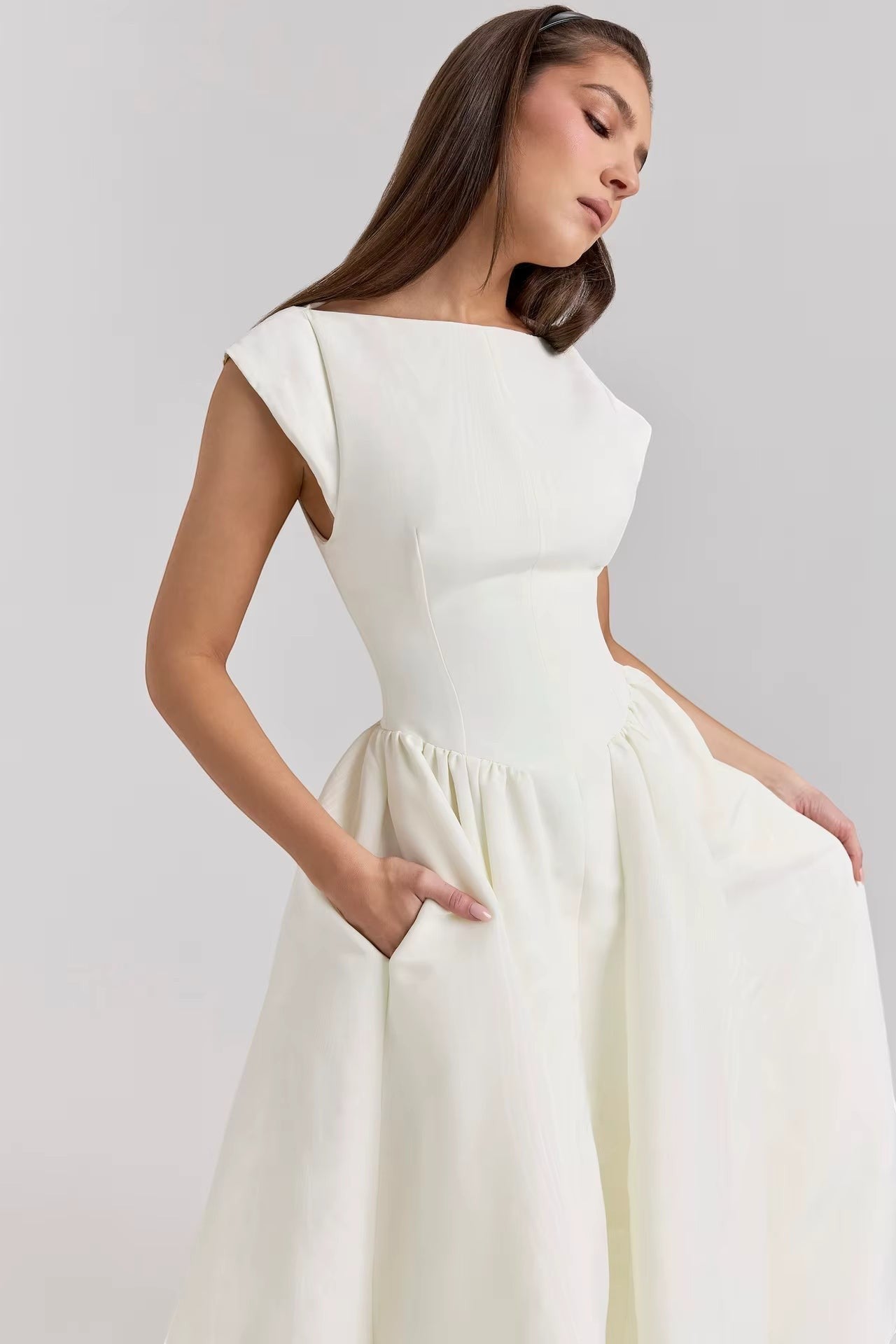 White cap-sleeve midi dress with scooped neckline, defined waist, and gathered skirt