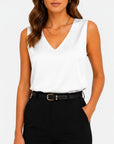 White satin sleeveless V-neck blouse with draped neckline.