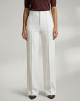 High-waist tailored trousers in white with belt loops and front button closure