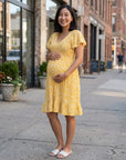 Yellow floral maternity dress with V-neck and flutter sleeves, knee-length