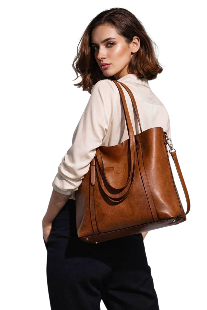 Cognac leather tote bag with long shoulder strap and front pocket detail