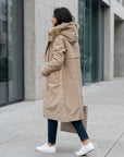 Tan waterproof hooded parka with faux fur trim, button front, long sleeves
